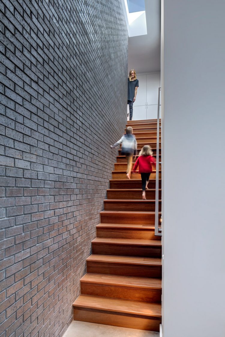a narrow wooden staircase leads to the upper floor