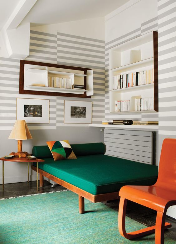 Striped walls and a bold green couch Striped walls and a bold green couch