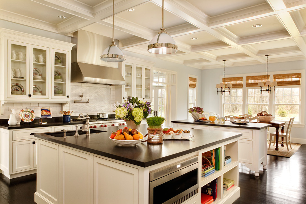 Picture Of two traditional kitchen islands provide lots of storage and