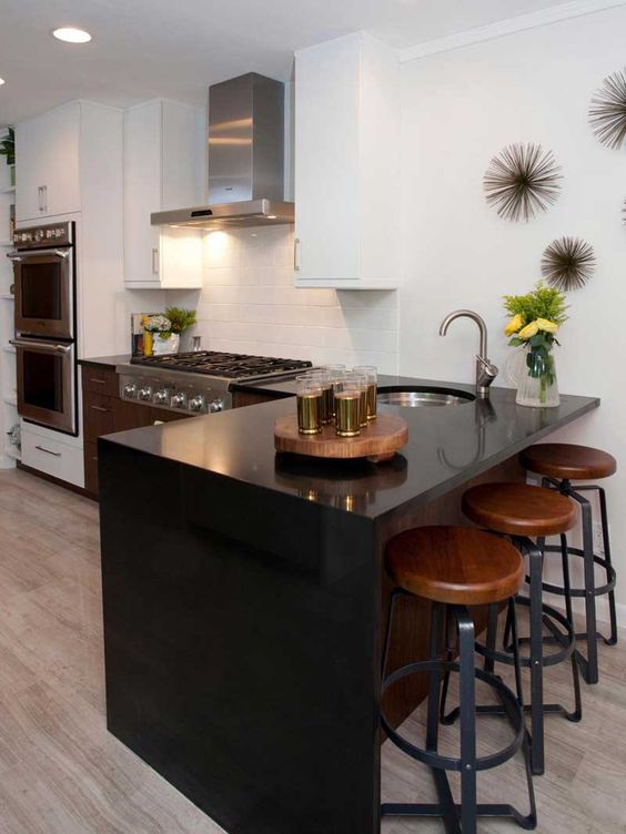 a sleek look effect is provided with a black quartz waterfall countertop, which is durable