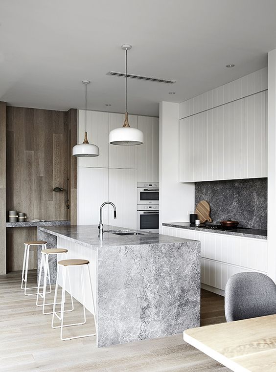 the waterfall countertop echoes with the backsplash