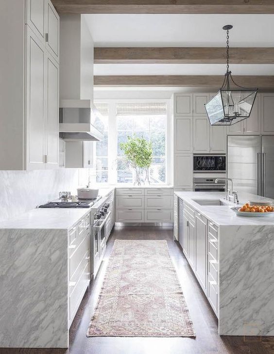 grey and white quartzite waterfall edge countertops emphasize modern aesthetics