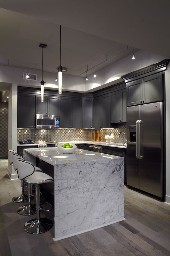 grey shaker cabinets look pulled off with a neutral-colored marble countertop