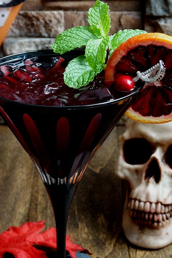 bloody zombie rum cocktail with a pirate-themed stirrer
