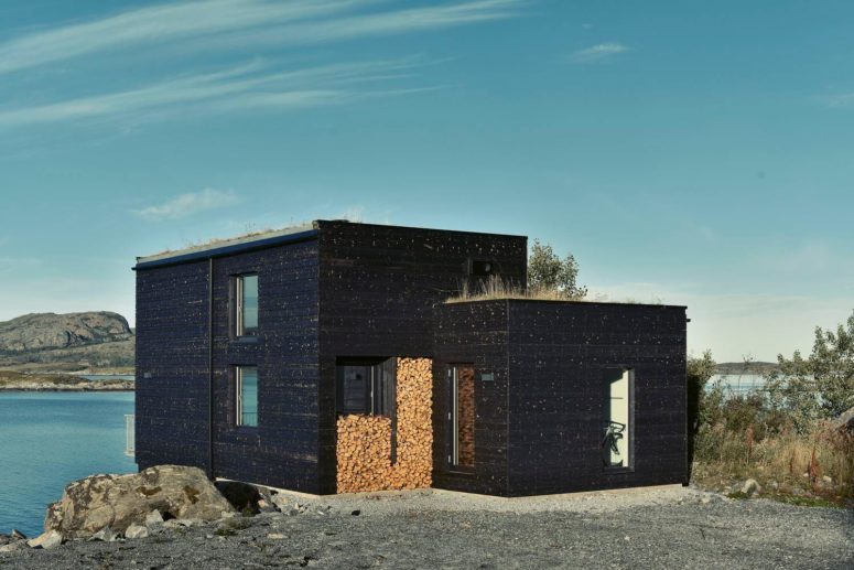 The facade is covered with dark weathered wood, which perfectly blends with the harsh Scandinavian nature The facade is covered with dark weathered wood, which perfectly blends with the harsh Scandinavian nature