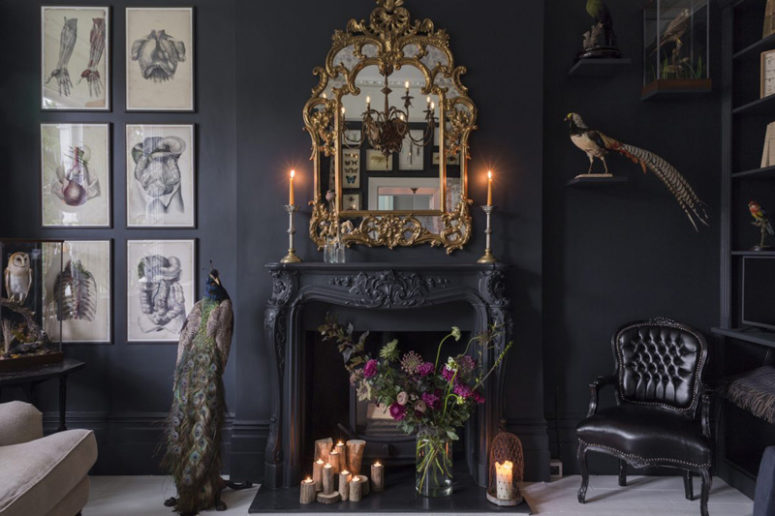 the antique fireplace is a focal point with candles and a refined gilded frame mirror