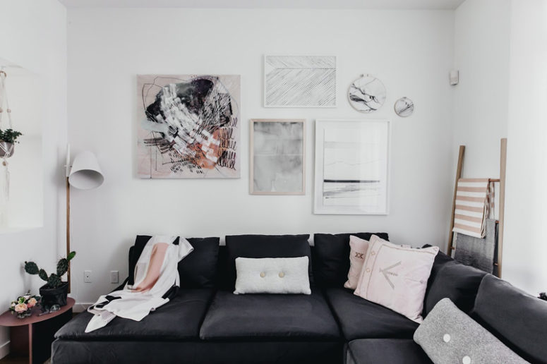 scandinavian living room The artworks and blush pillows spruce up the Scandinavian interior of the living room