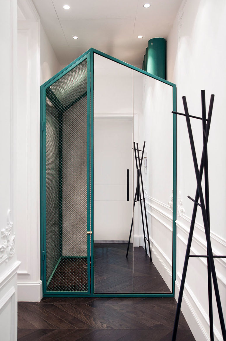 This turquoise frame stands out among white walls with stucco