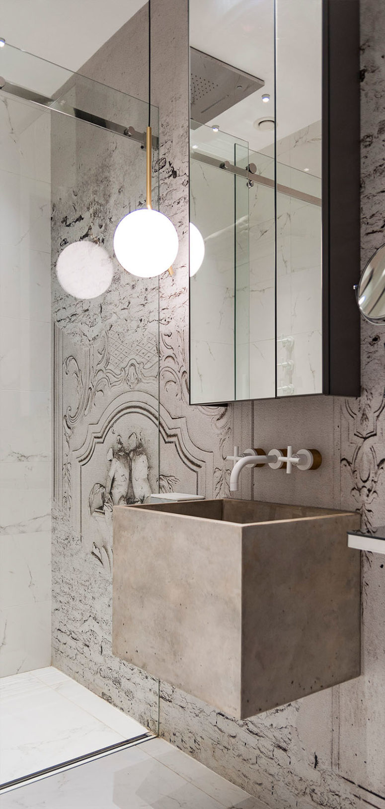 Another bathroom has a concrete sink and another unique mural