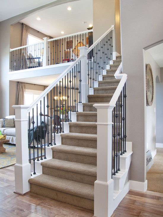traditional stairs of white wood and wrought iron design