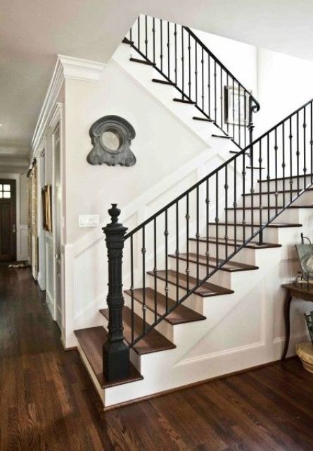 sharp-looking staircase with metal posts and wrought iron railing