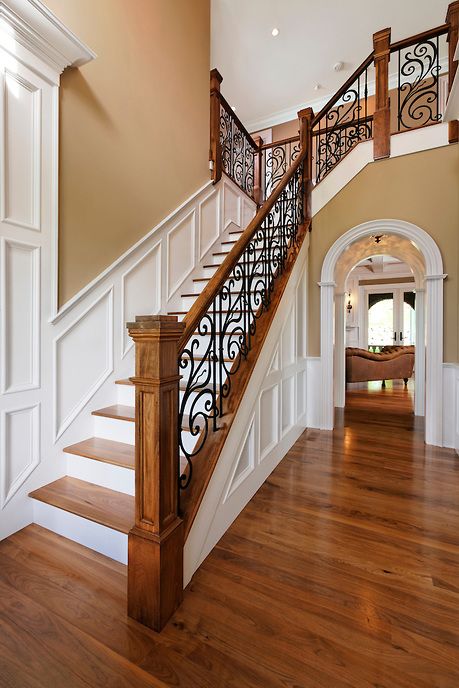 traditional oak staircase with worugh iron railing