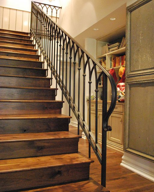 rustic stairs of wood with a wrought iron handrail and banister