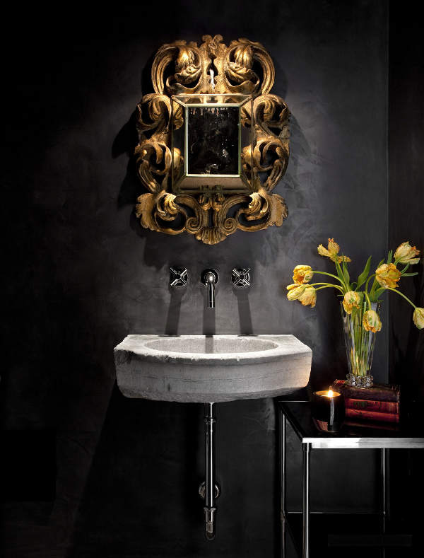 all black bathroom design The bathroom is done in black, with a concrete sink and a refined gold frame mirror