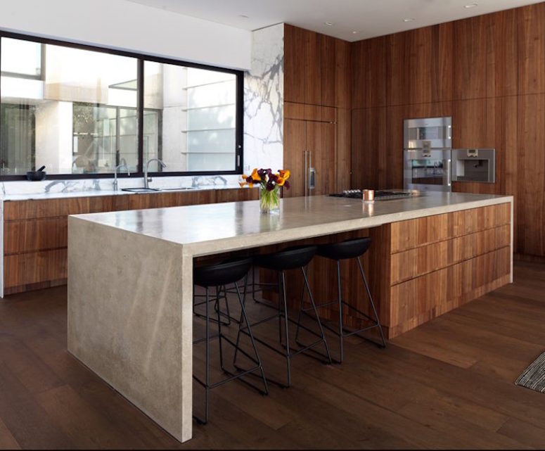 bold wood kitchen design The kitchen is done in warm-colored wood, polished concrete and marble