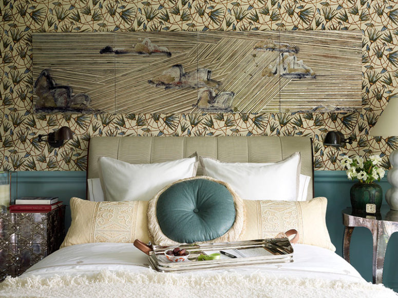 floral wallpaper in a bedroom The graphic floral wallpaper coveres the walls and there's wainscoting in the same blue shade