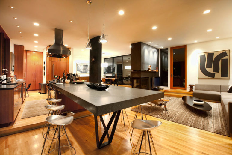 masculine kitchen island The kitchen features a large concrete kitchen island and a breakfast table at the same time