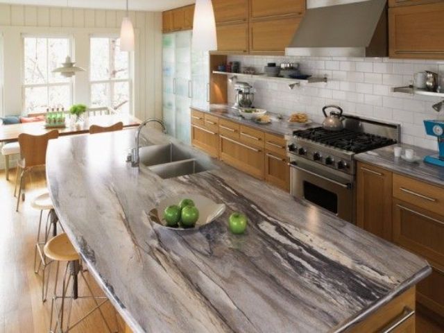 a chic granite counter contrasts with warm-colored cabinets of wood