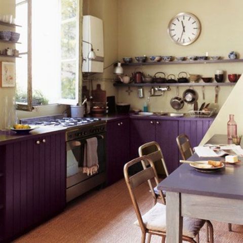 purple kitchen cabinets and creamy walls look interesting