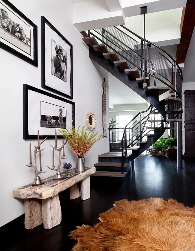 cozy fur rug in an entryway The entryway has a cool staircase, a faux fur rug and a rough wood bench