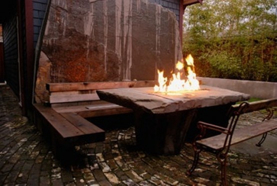 An outdoor entertaining area that feature a water wall and a fire bowl at the same time would definitely be cozy.