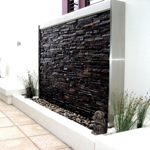 Stacked stone panel framed in stainless steel.