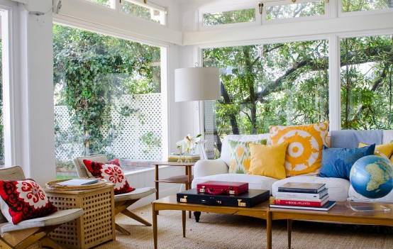 an amazing sunroom with a tree behind the window 554x351 Chia sẻ bộ sưu tập 55 thiết kế nhà kính tuyệt đẹp