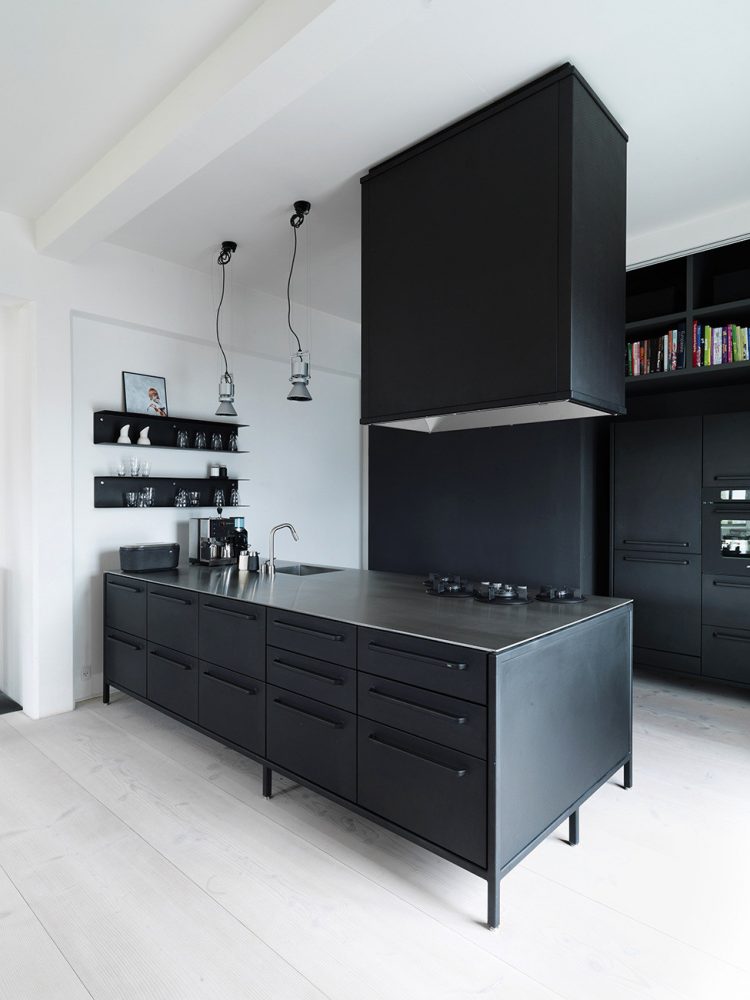 Functional Scandinavian Loft Of A Famous Architect even a kitchen island with a cooking hood above it are all black