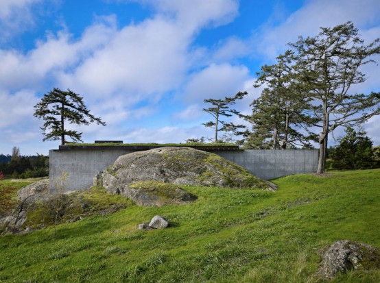 House With A Contrasting Interior Nestled Into The Rocks