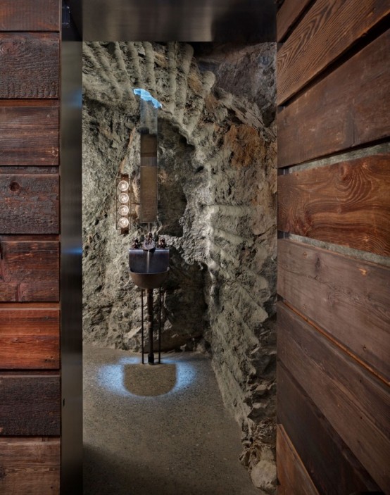 House With A Contrasting Interior Nestled Into The Rocks