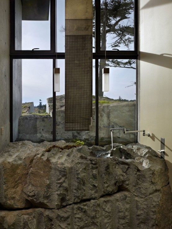 House With A Contrasting Interior Nestled Into The Rocks