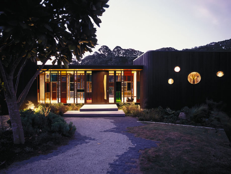 SingleStory Two Wings House with Dark Cedar Cladding on Hot Water