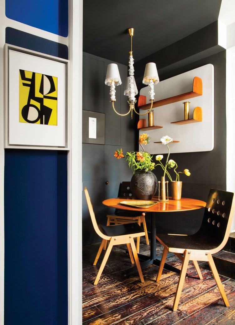The dining zonemixes graphite black and orange or brass touches