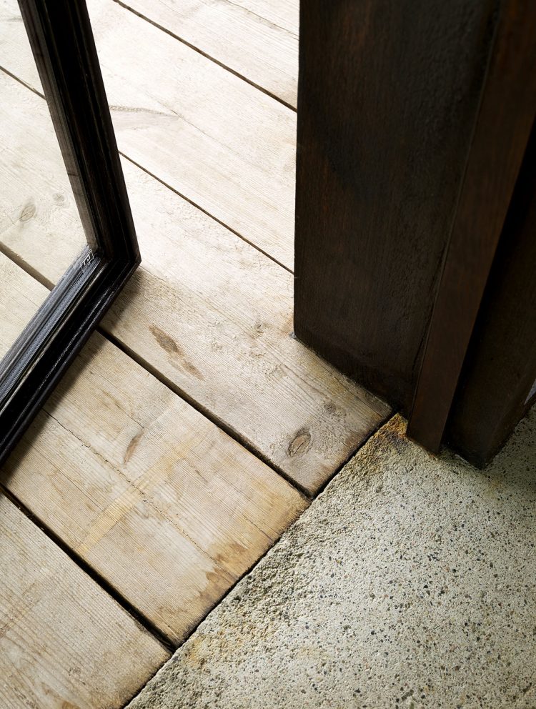 concrete floors inside and a wooden deck outside