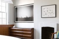 06 artworks and a fireplace give the bedroom an original look