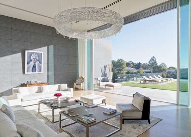 The glam living room features a portrait of Queen Elizabeth II as the designer is from London