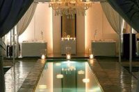 07 small indoor pool with lamps around and a stunning chandelier