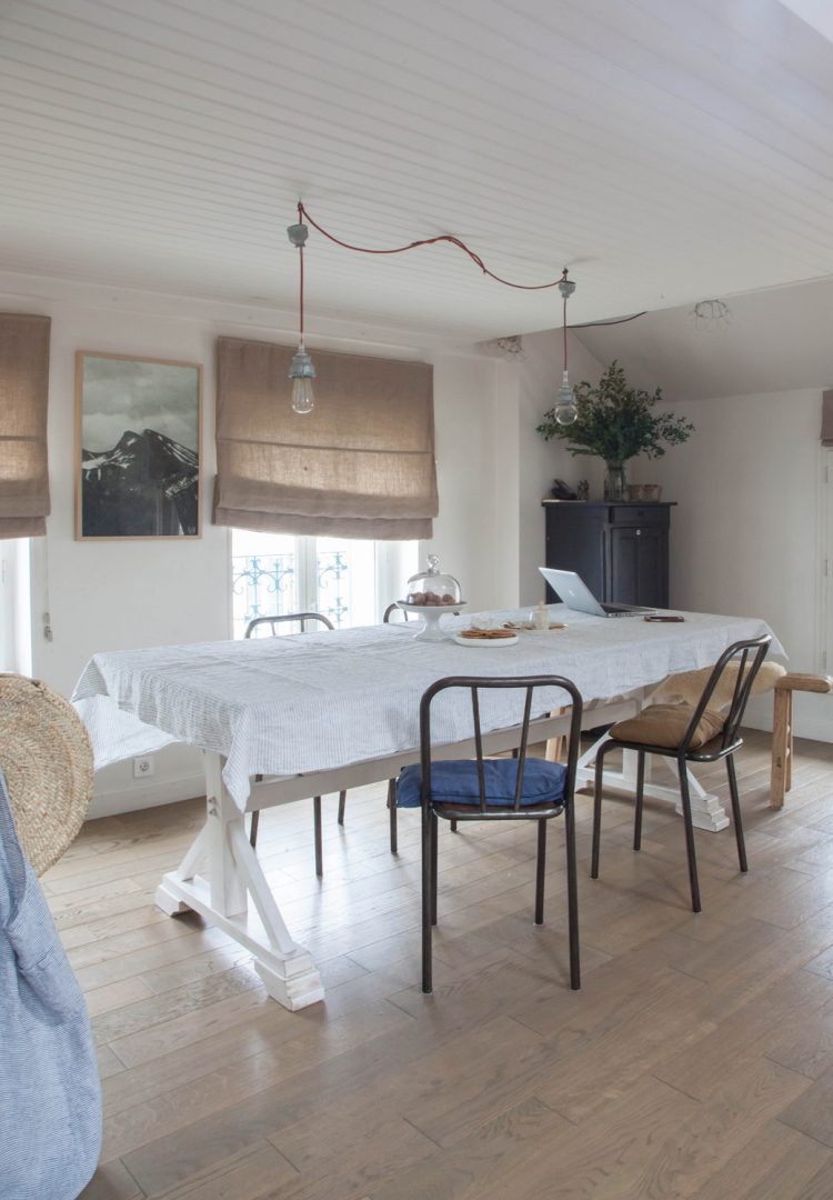 wooden floors and burlap curtains add rustic coziness