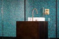 11 mosaic bathroom tiles contrast with a metal sink stand