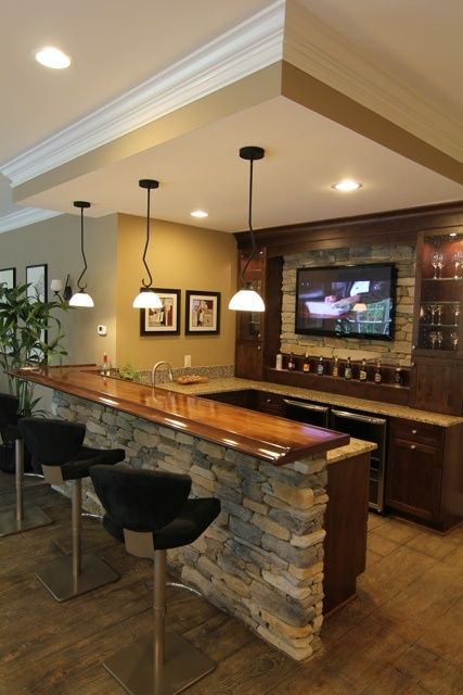 basement bar with a stone countertop