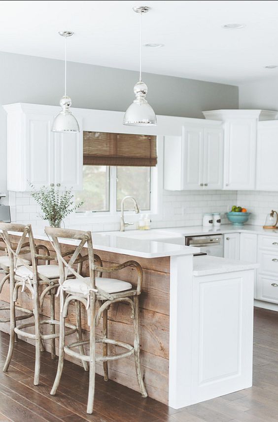 kitchen island with a dining table and cool rough wood finish