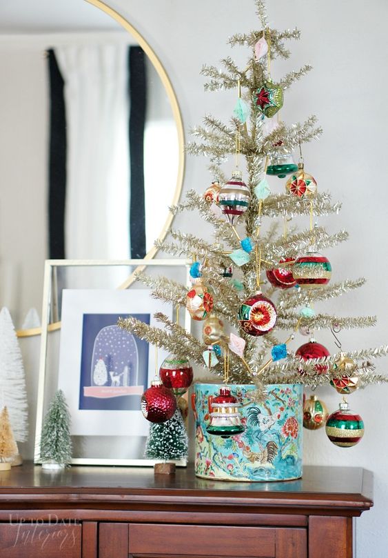 a gold vintage Christmas tree decorated with colorful vintage ornaments is a pretty idea to go for