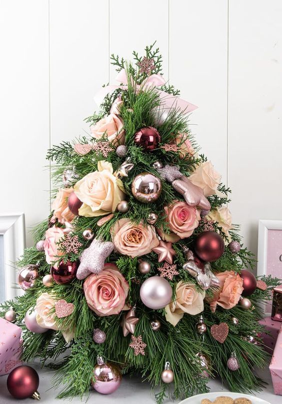 a pretty glam tabletop Christmas tree decorated with metallic and pastel ornaments, with glitter stars and pastel blooms