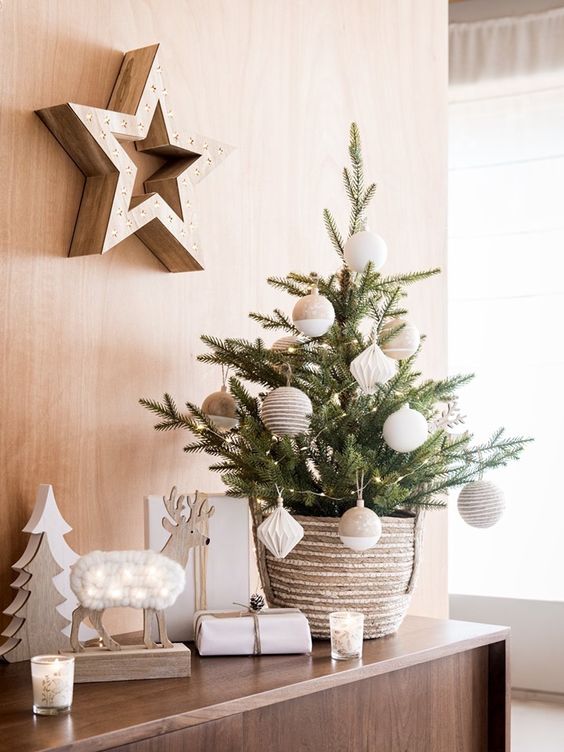 a stylish and simple tabletop Christmas tree decorated with twine and color block neutral ornaments and put into a crochet basket