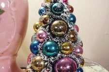 a vintage tabletop Christmas tree in a vintage cup, with pastel ornaments is a lovely idea for your vintage space