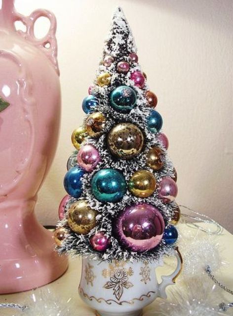 a vintage tabletop Christmas tree in a vintage cup, with pastel ornaments is a lovely idea for your vintage space