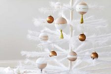 a white tinsel Christmas tree decorated with brown, white and blush ornaments is an ethereal idea to go for