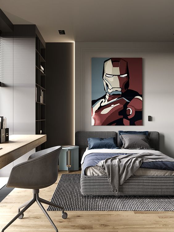 a contemporary teen bedroom with an upholstered bed, a large storage unit and built-in lights, a desk and a grey chair plus a statement artwork