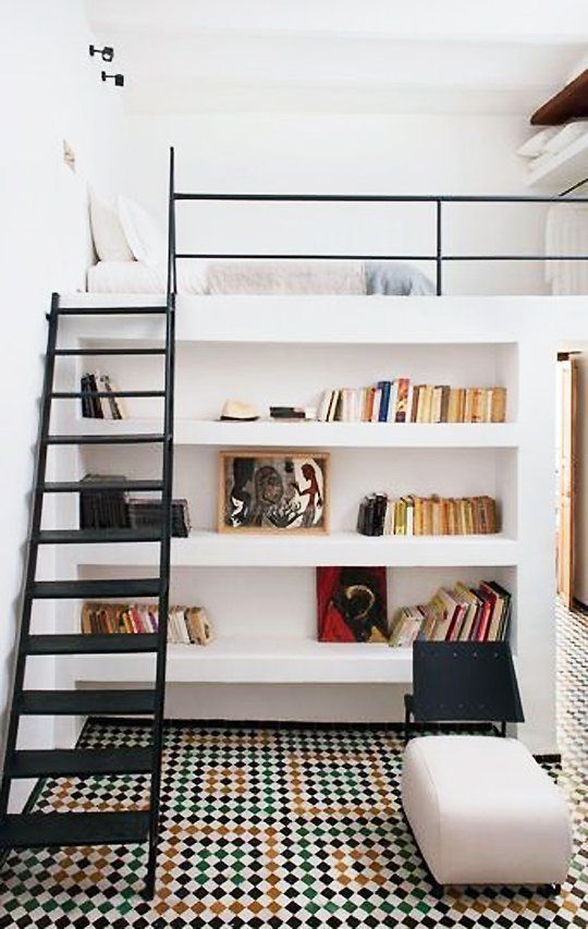 a creative teen room with a loft bedroom and closet and a reading space down with built-in shelves and an ottoman