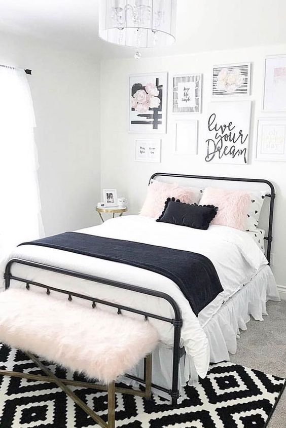 a lovely teen bedroom with a black metal bed, contrasting bedding, a pretty gallery wall and a pink faux fur bench